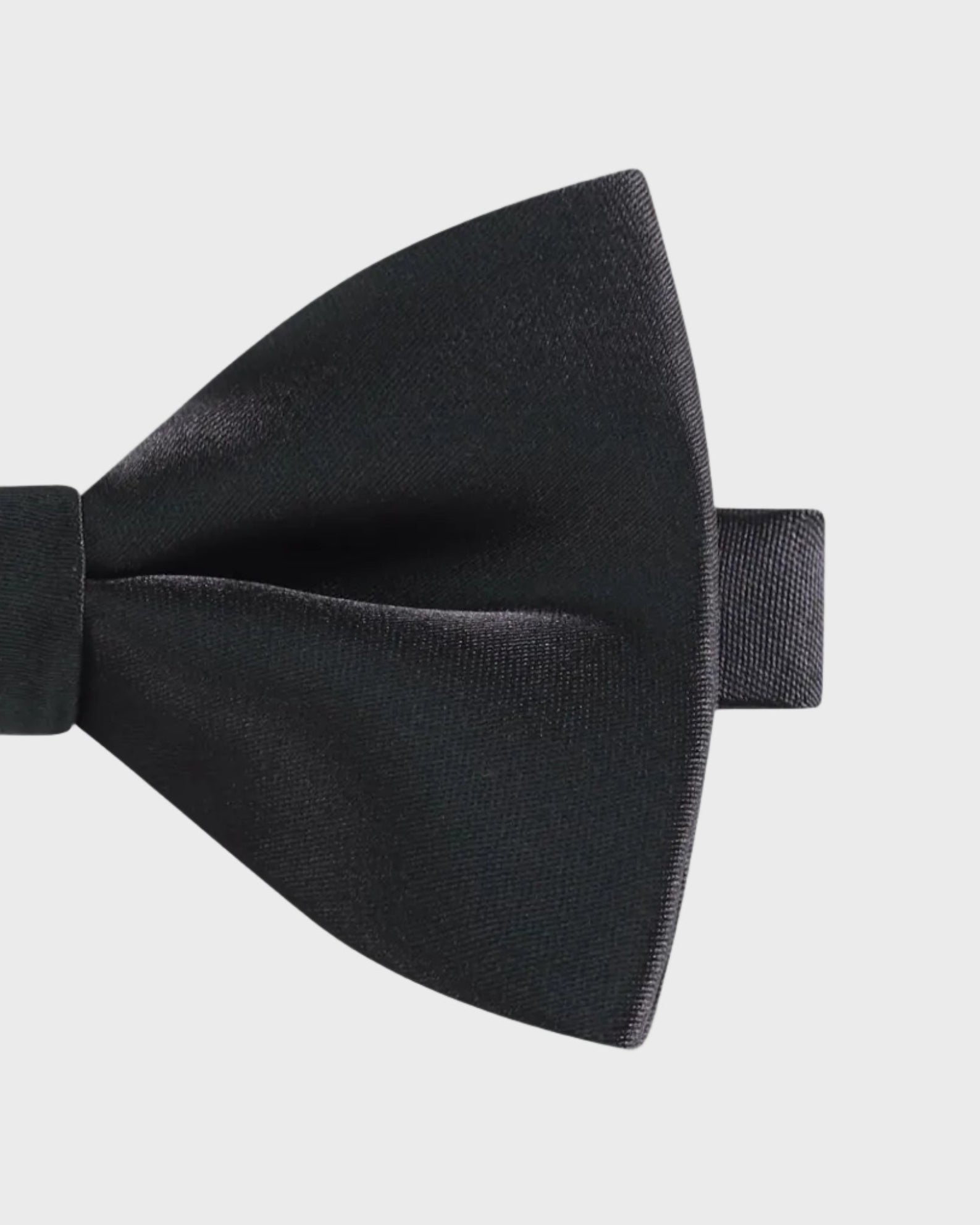 Black bow tie on a light gray background