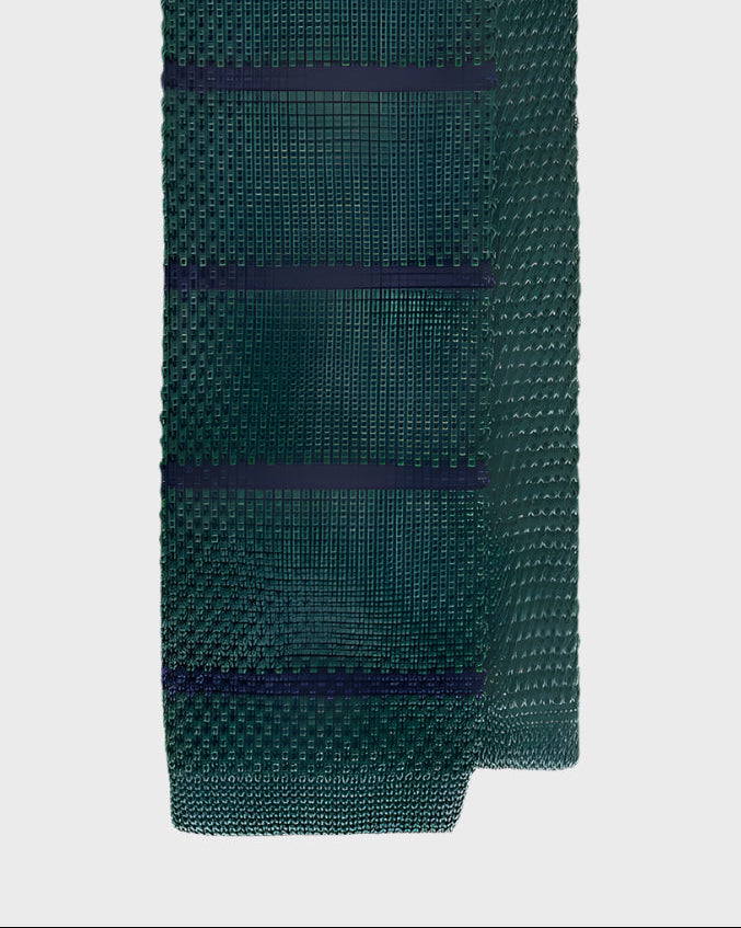 Green knitted tie with dark blue stripes on a light gray background