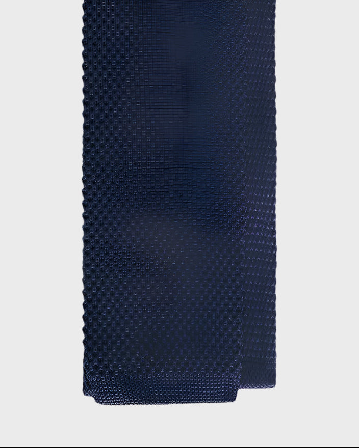 Navy blue textured tie on a light gray background