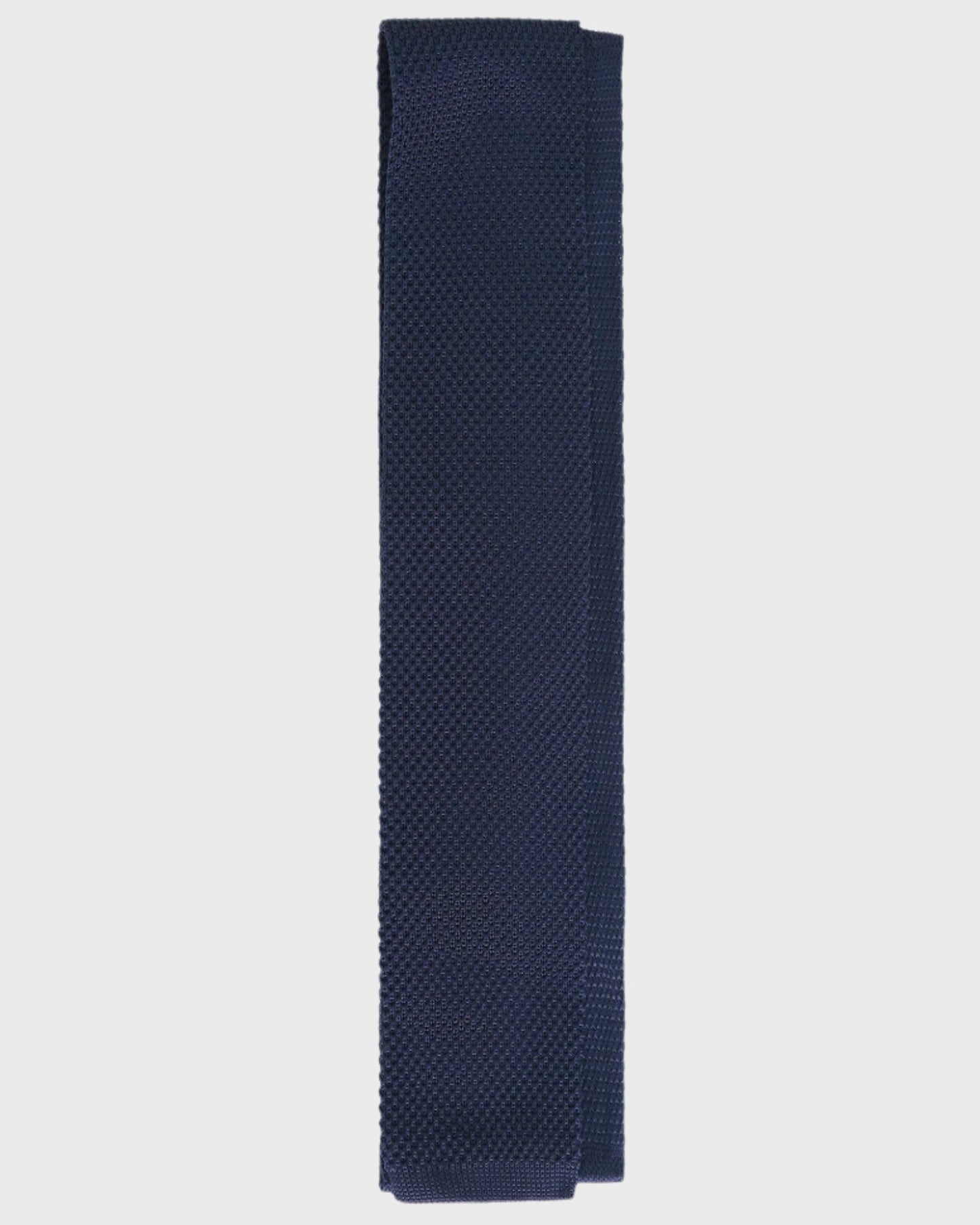 Navy blue textured tie on a light gray background