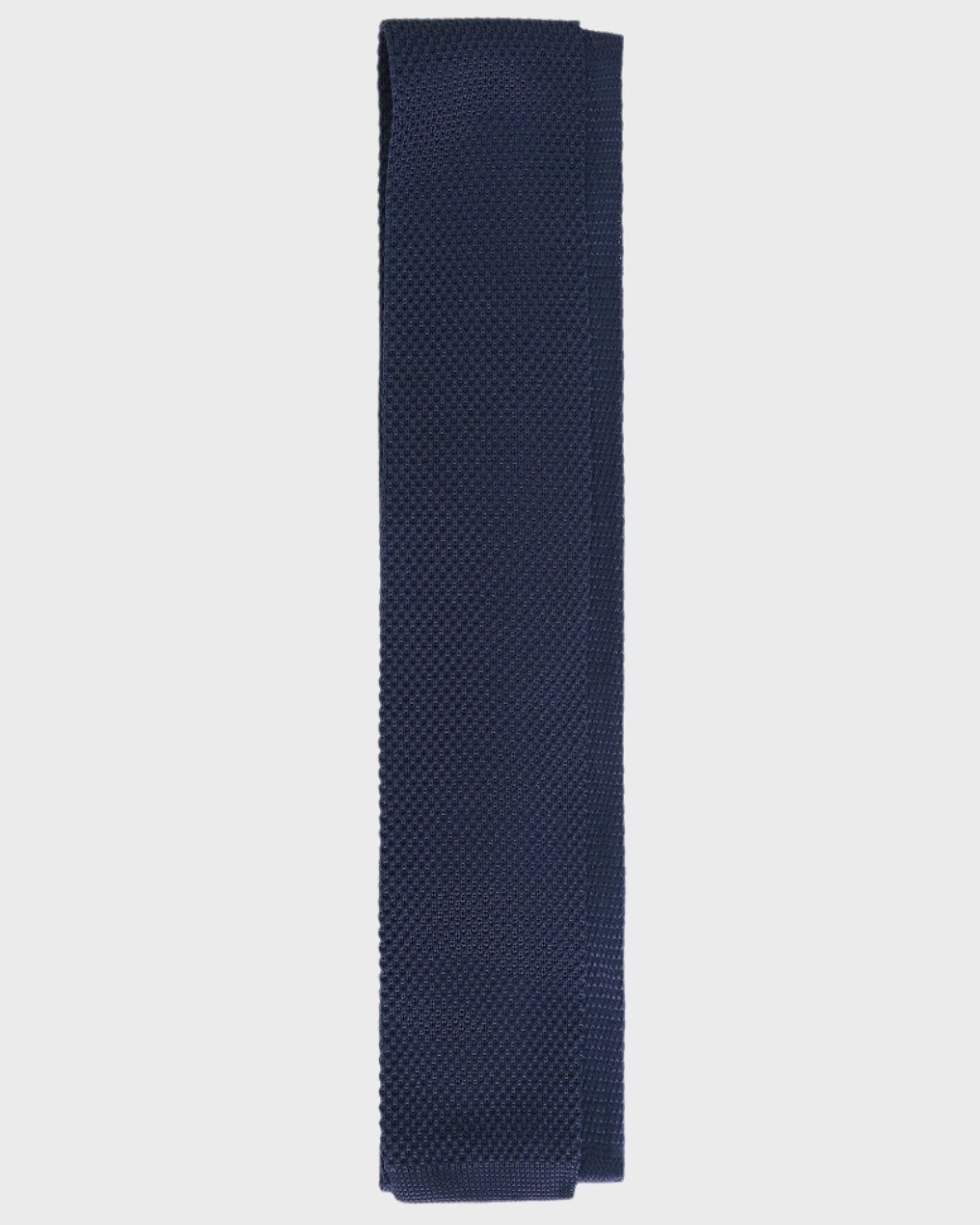 Navy blue textured tie on a light gray background
