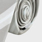 Rolled-up gray and white tie on a light gray background
