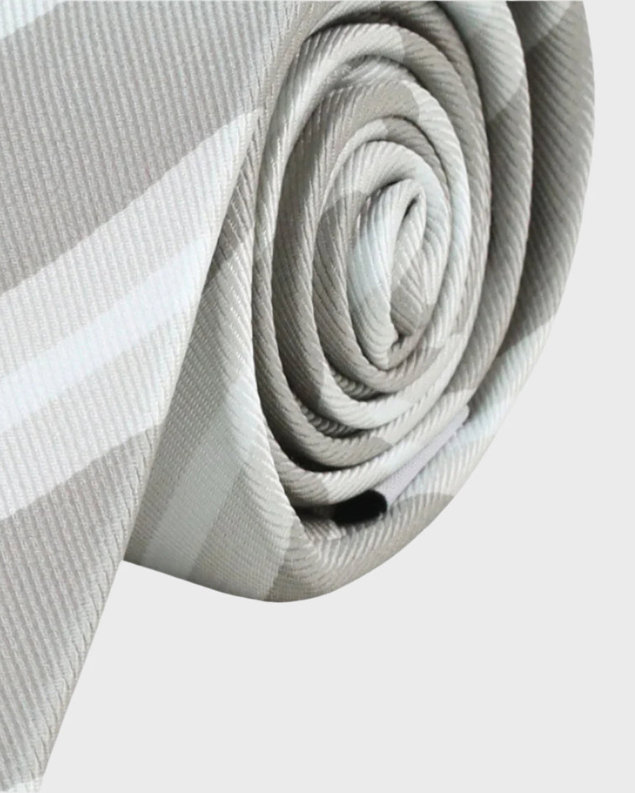 Rolled-up gray and white tie on a light gray background