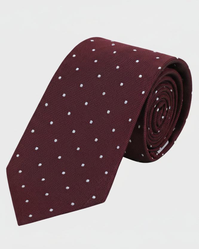 Maroon tie with white polka dots on a light gray background