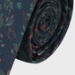 Rolled-up patterned tie on a white background