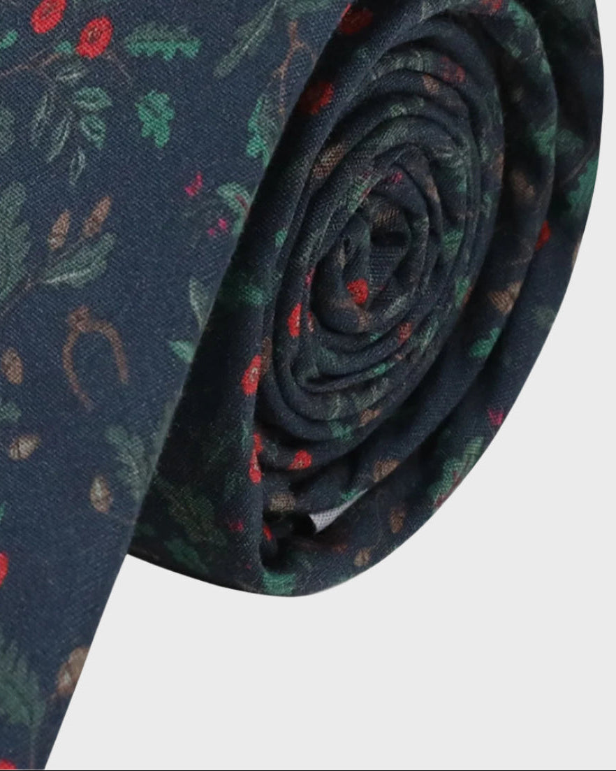 Rolled-up patterned tie on a white background