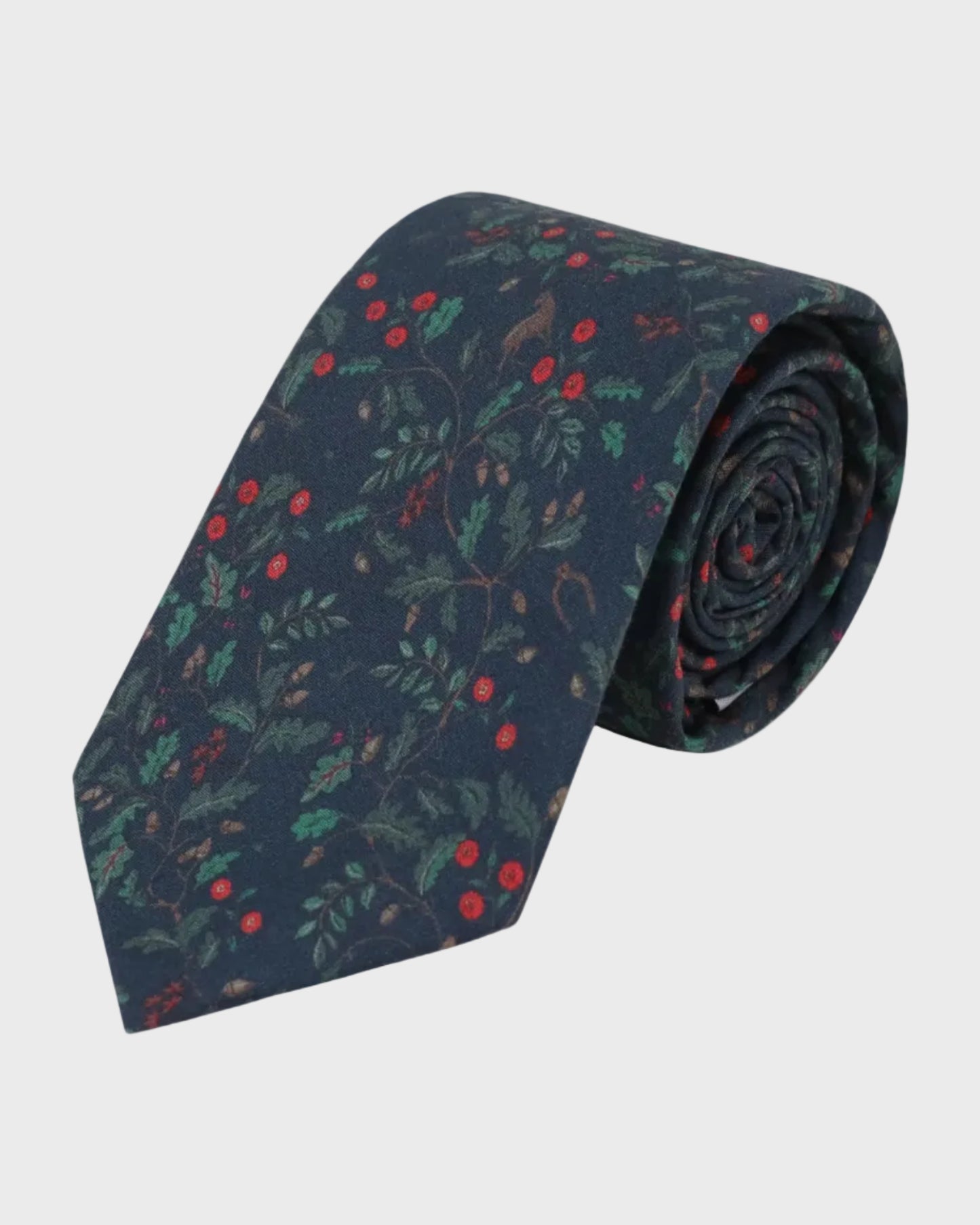 Navy blue tie with red and green leaf pattern on a light gray background