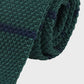 Green knitted tie on a white background