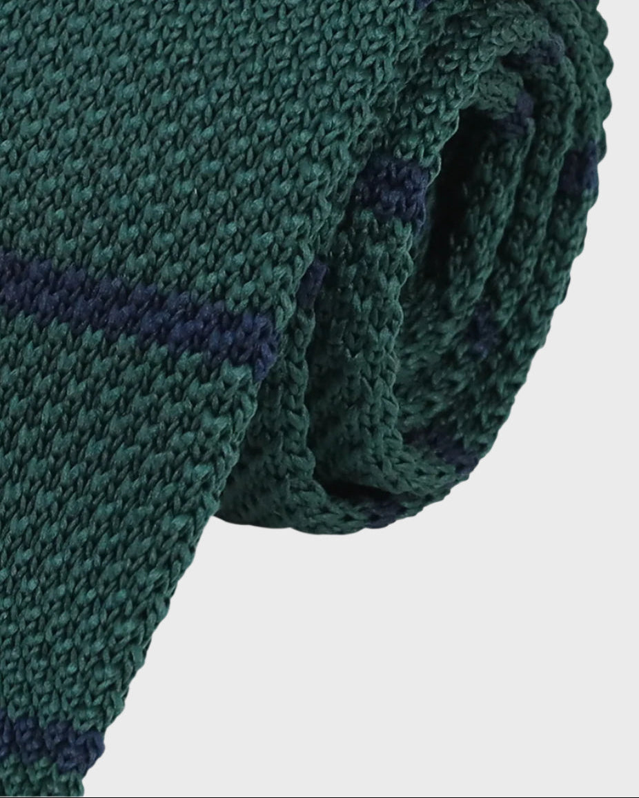 Green knitted tie on a white background