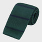 Green knitted tie with navy stripes on a light gray background