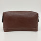Brown leather toiletry bag on a white background