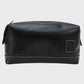 Black leather toiletry bag on a light gray background