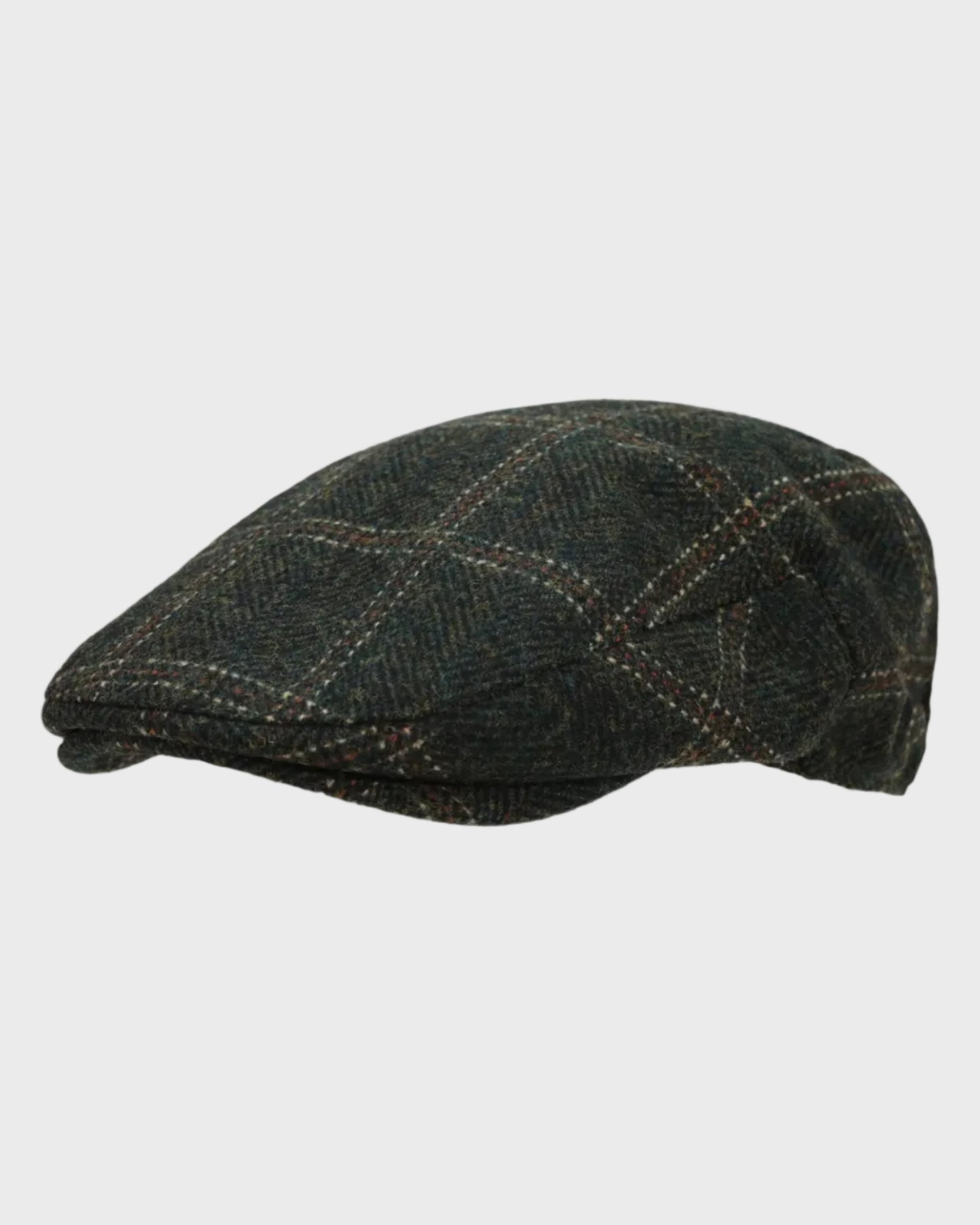 Harris Tweed flat cap on a light gray background