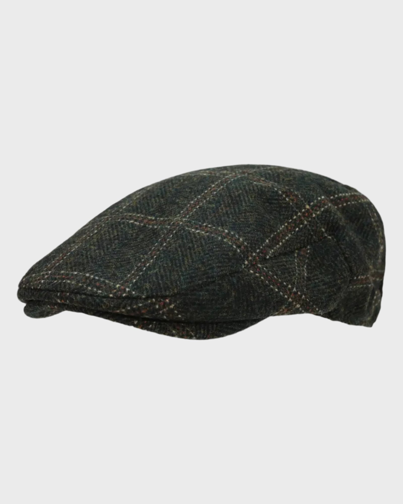 Harris Tweed flat cap on a light gray background