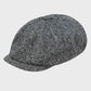 grey tweed pannel cap on a grey background