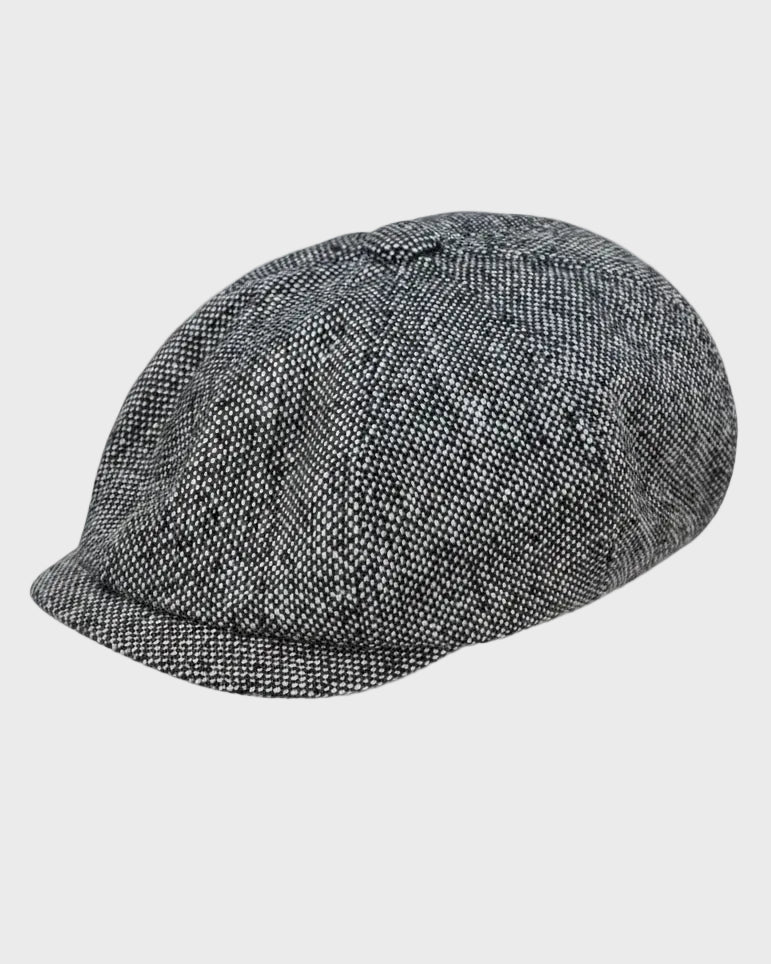 grey tweed pannel cap on a grey background