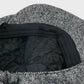Close-up of a textured fabric with black quilted lining on a white background