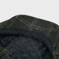 Harris Tweed cap with quilted lining on a light gray background
