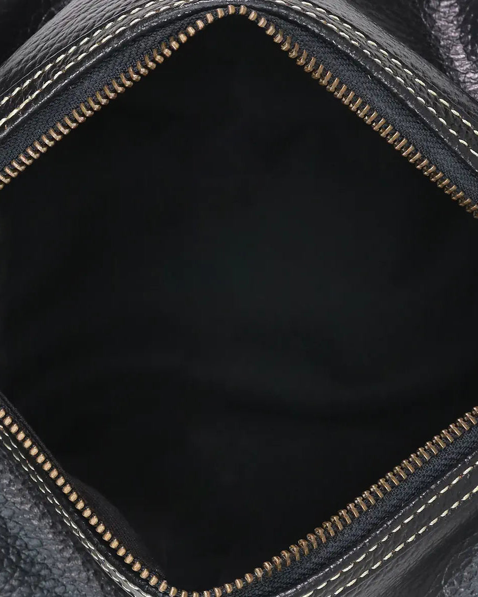 Close-up of a black leather bag with visible stitching details.