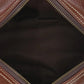 Close-up of a brown leather bag with visible stitching