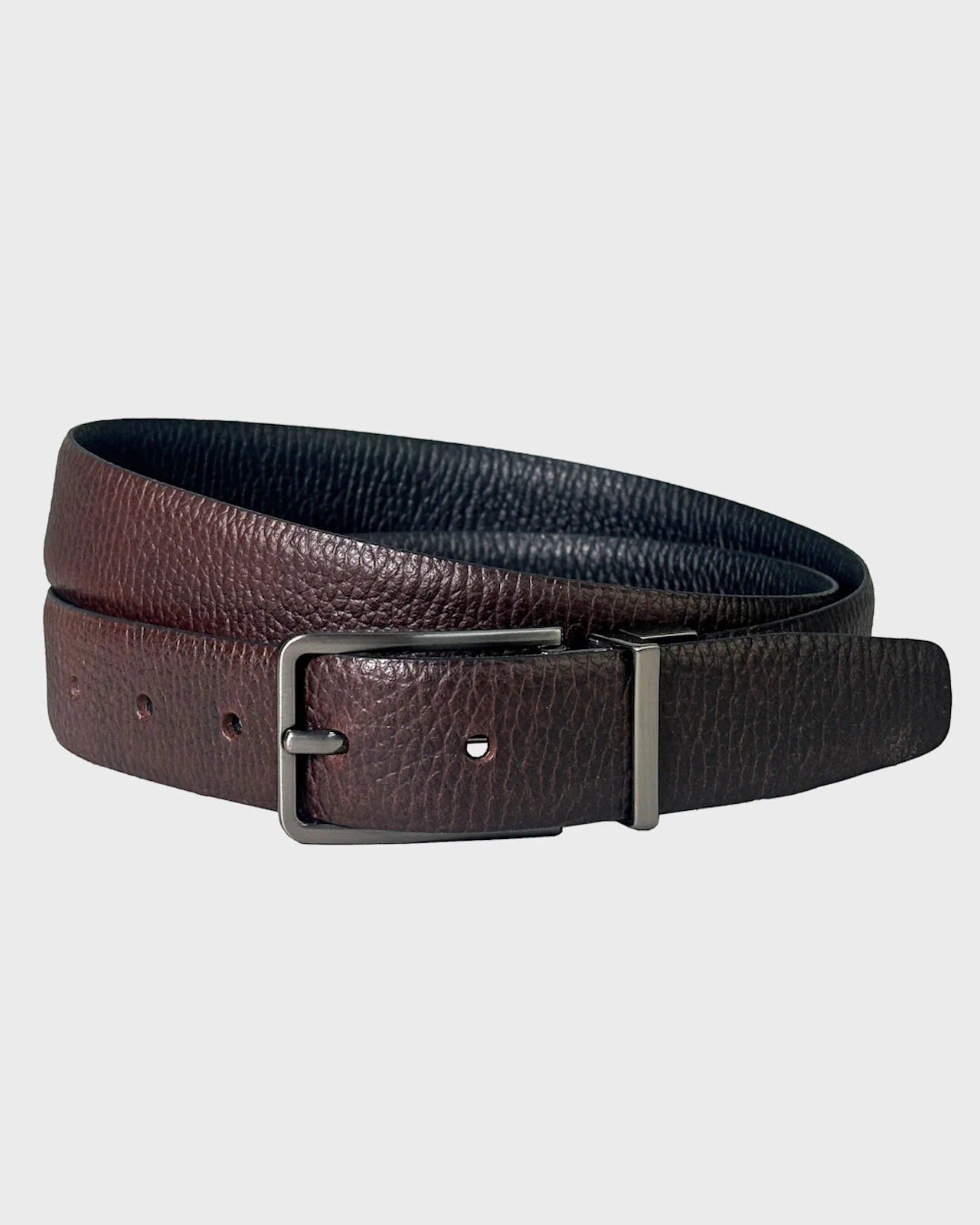 Brown leather belt with a silver buckle on a light gray background
