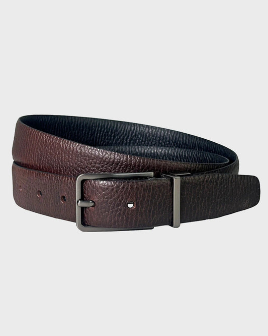 Brown leather belt with a silver buckle on a light gray background