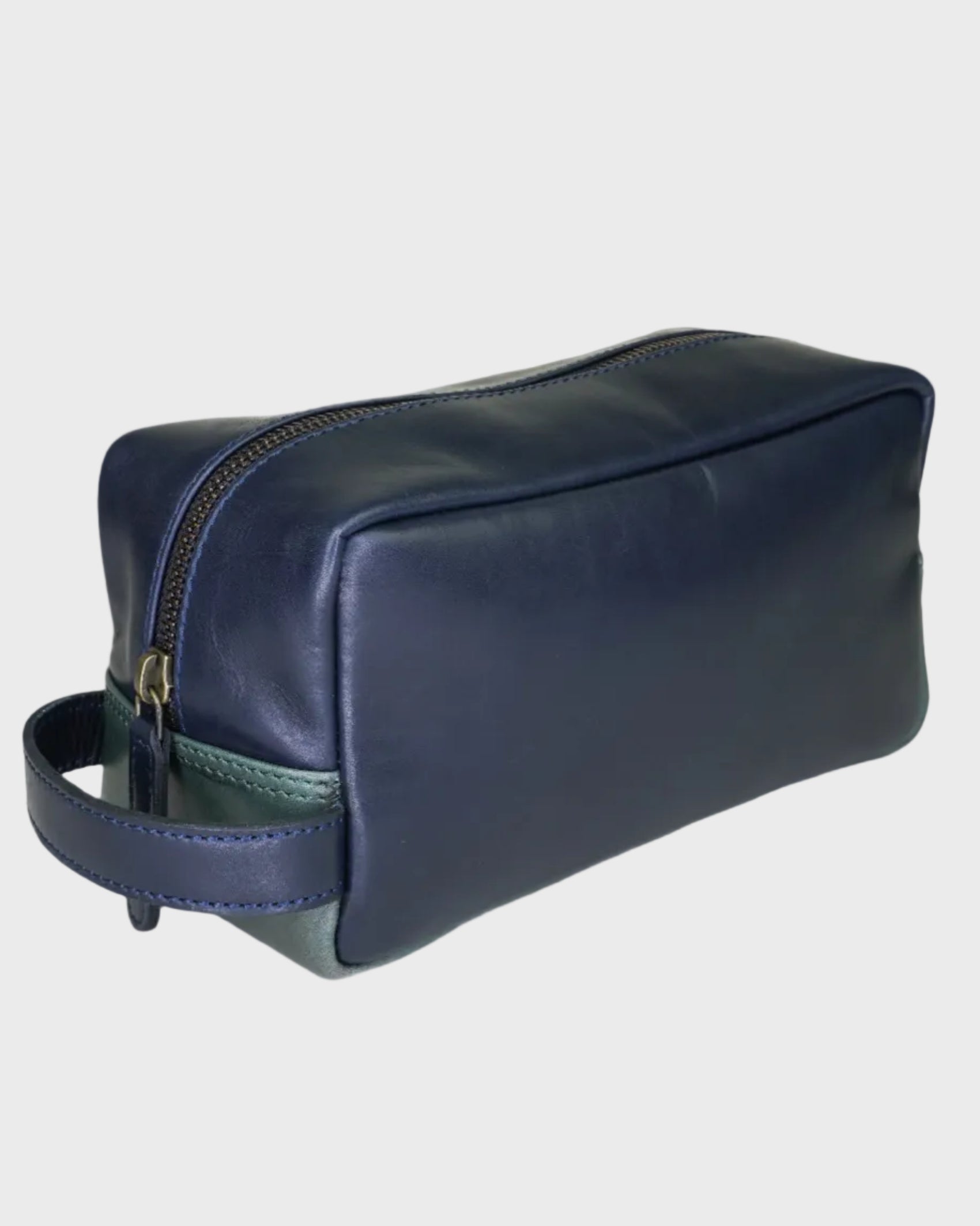 Navy leather toiletry bag on a light gray background