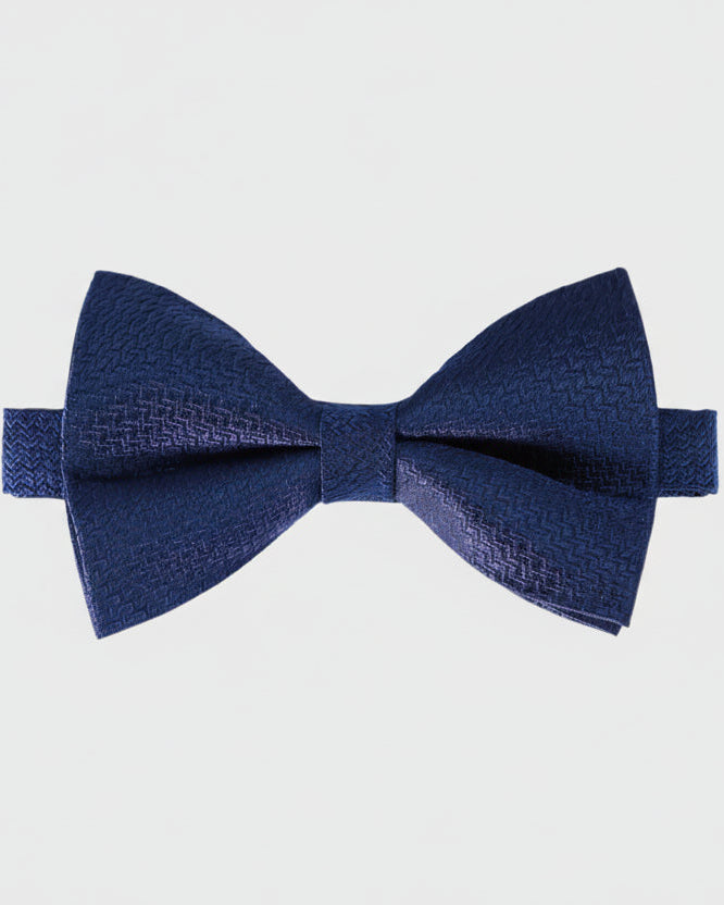 Navy blue bow tie on a light gray background