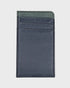 Navy and green cardholder on a light gray background