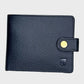 Black leather wallet with a gold button on a light gray background
