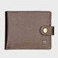 Brown leather wallet with a gold button on a light gray background