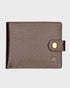 Brown leather wallet with a gold button on a light gray background