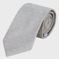 Gray tie with white polka dots on a light gray background